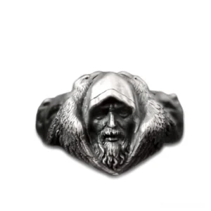 Viking wolf ring with blackened stainless steel finish displaying intricate Odin carving and wolf motif flat lay front view
