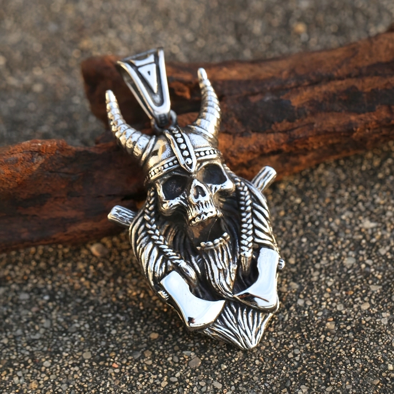 Viking skull warrior axe pendant detailed close-up - vintage stainless steel carving - low angle photography