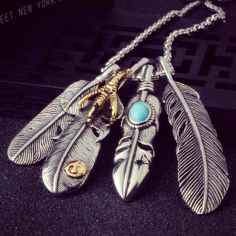 Complete view of vintage feather pendant necklace collection showing various claw and feather design variations