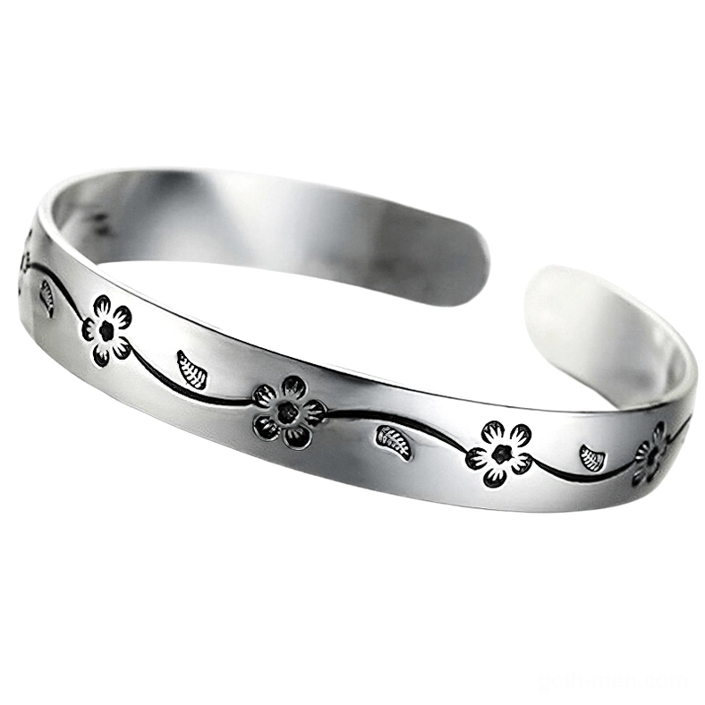 Adjustable open cuff gothic silver bangle with polished finish and etched blossom patterns, front flat lay display