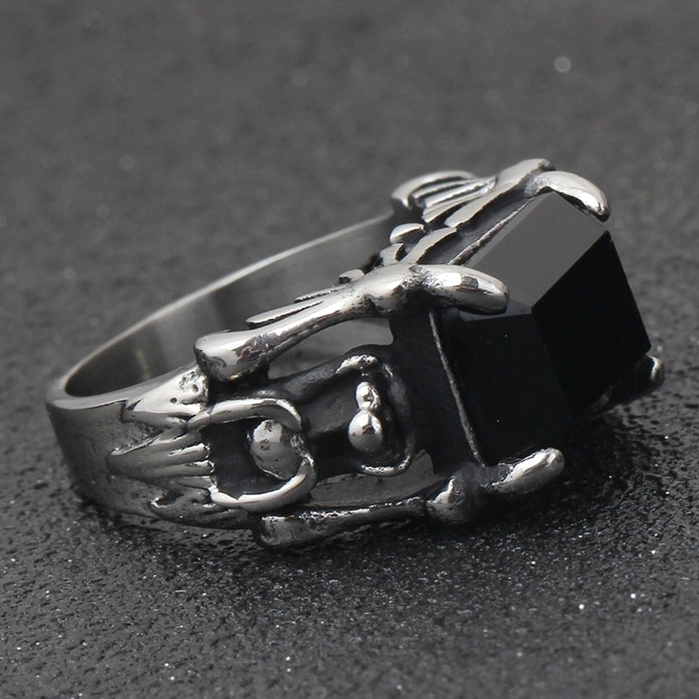 Aged silver stainless steel gothic ring with ornate metal frame and square black zircon stone, flat lay top view