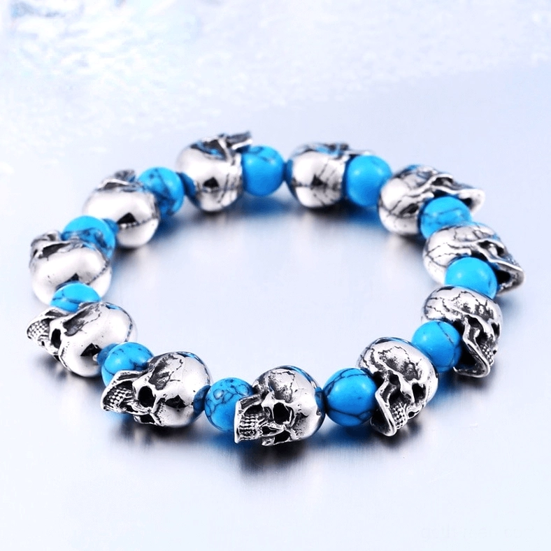Silver skull beads with blue round stone accents on elastic bracelet, light background display