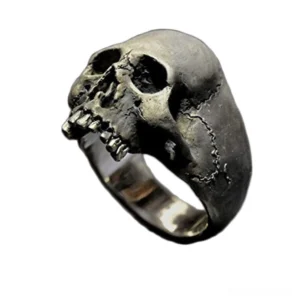 Vintage silver skull ring front overhead view with aged patina finish and detailed skull carving