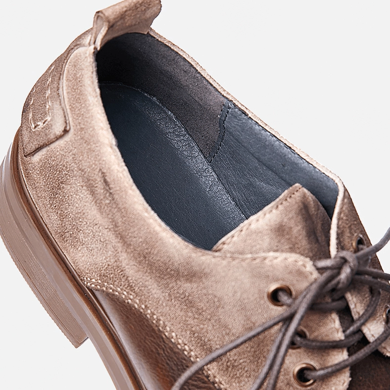 Pair of men's vintage-style dark leather lace-up gothic boots showing craftsmanship, stitching detail, and aged leather patina