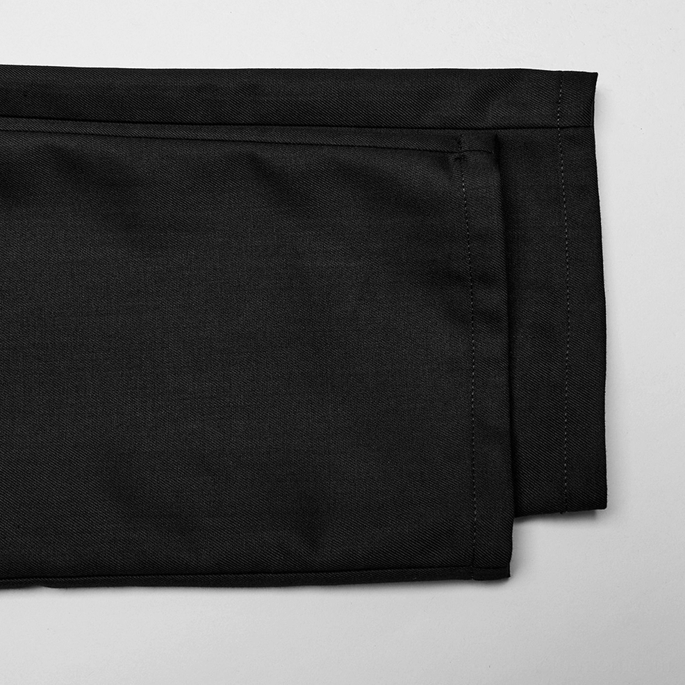 Waistband hem folding and tailoring detail of black gothic cargo trousers, precision craftsmanship closeup