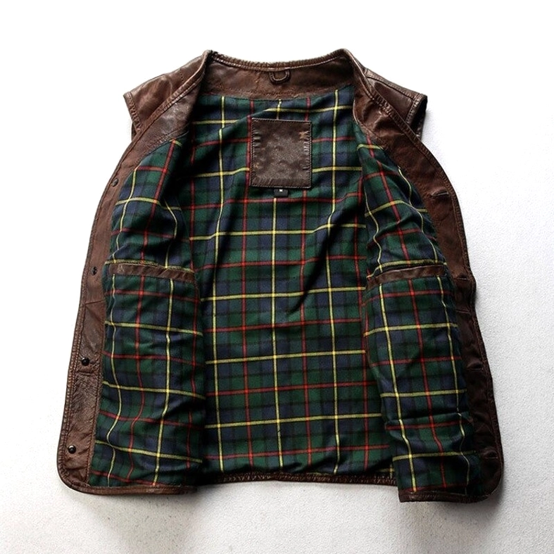 Interior detail of gothic leather waistcoat featuring green tartan plaid lining and inner brand label