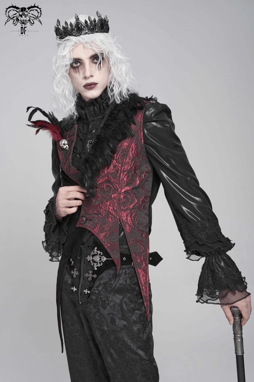 Detailed side angle of gothic waistcoat displaying layered feather trim, rose jacquard pattern, and black velvet accents