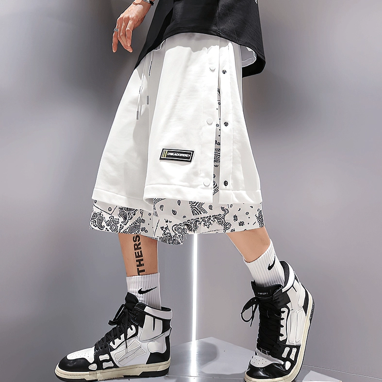 White gothic alternative shorts full model view showing knee-length cut and relaxed fit with sneaker pairing