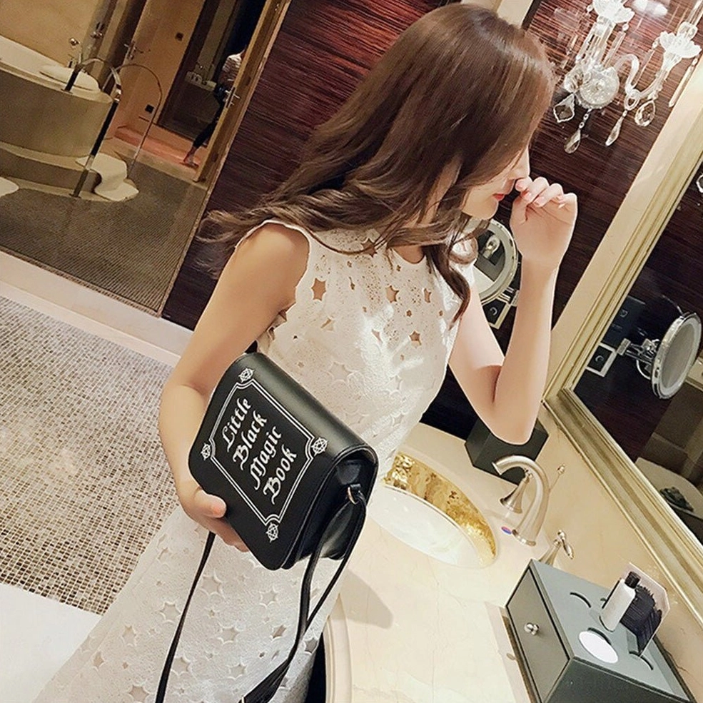 White gothic letter crossbody bag showing front panel design and text printing details