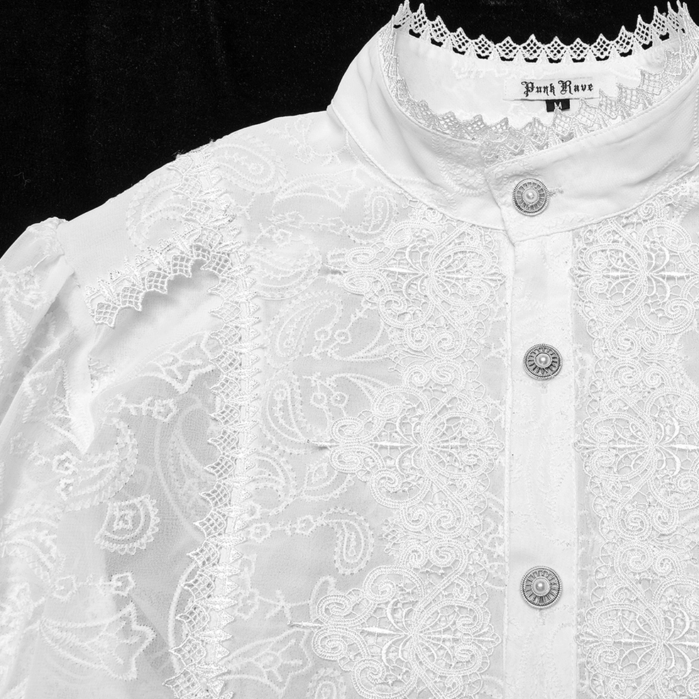 Detailed shot of white gothic shirt front placket with paisley embroidery, gem buttons, and sheer embroidered fabric texture