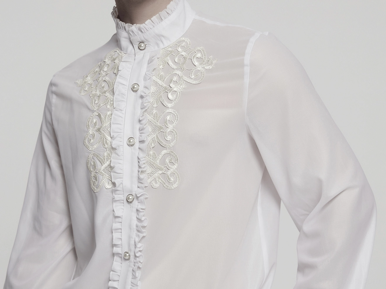 Male model rear view wearing white gothic ruffle shirt with sheer bishop sleeves and structured silhouette