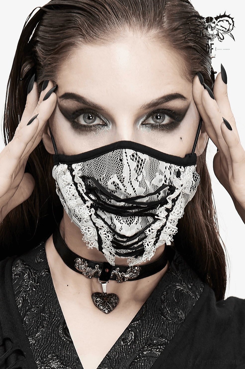 White and black gothic lace face mask styled as part of dark alternative fashion ensemble with gothic accessories