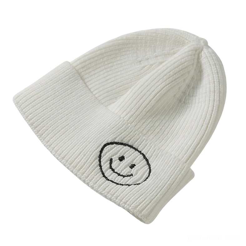 White ribbed knit beanie with dark outlined smiley embroidery, ethereal gothic style
