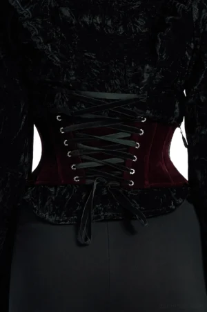 Back view of burgundy velvet gothic underbust corset showing adjustable eyelet-laced closure and black ribbon tie