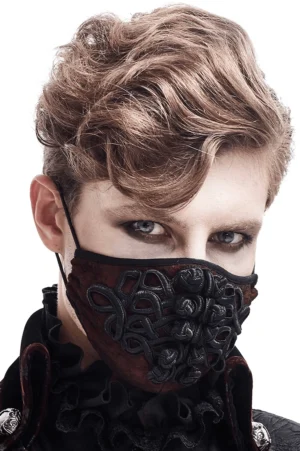 Gothic wine red embroidered face mask with black knot embroidery, front close-up on male goth model with retro hairstyle