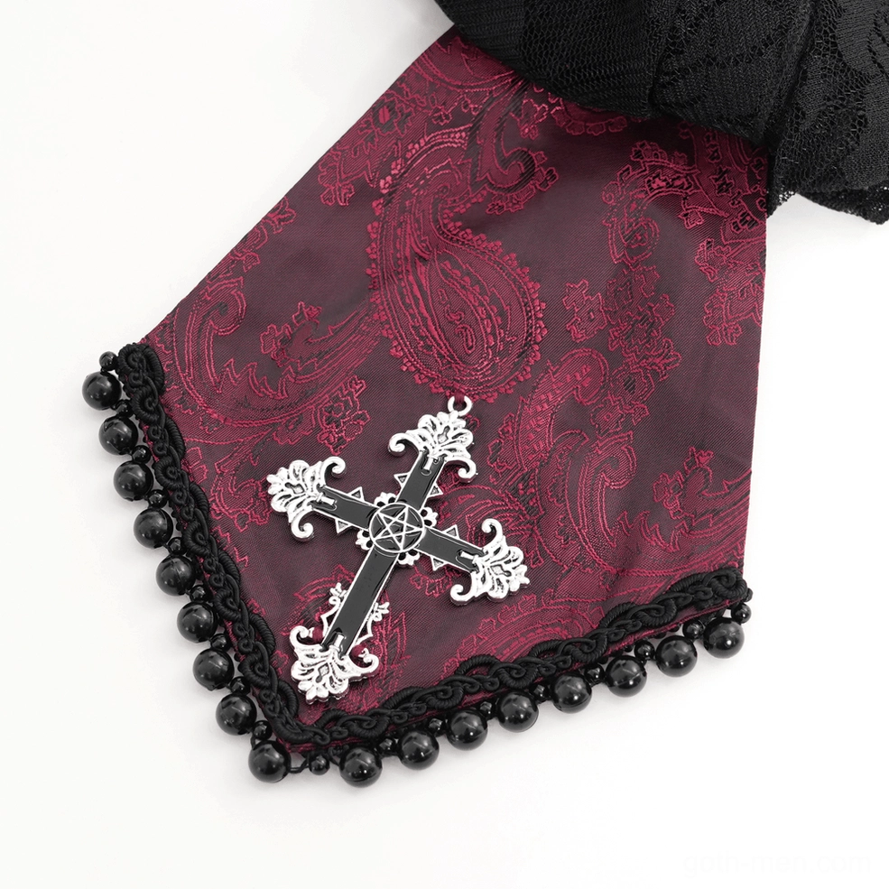 Extreme close-up of wine red Victorian gothic shirt showing silver cross brooch and black beaded lace trim detail