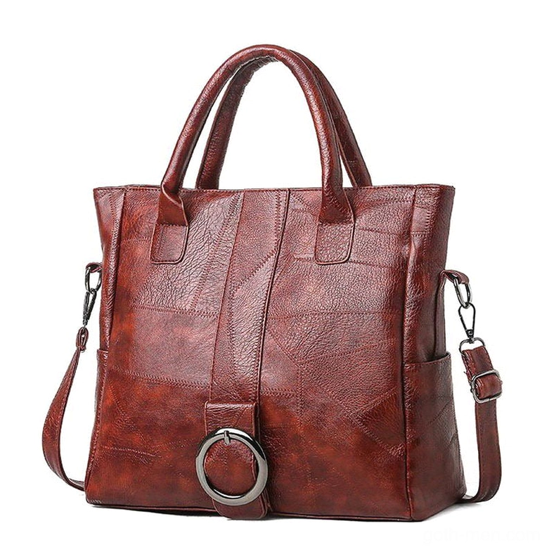 Wine red retro gothic leather tote with metal ring detail and adjustable crossbody strap - studio product shot