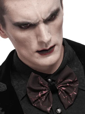 Male model wearing wine red jacquard gothic lace-up bow tie with formal dark alternative fashion styling and gothic makeup