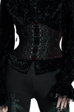 Wine red velvet gothic corset belt with black lace-up front and floral embroidery, worn by model in studio setting