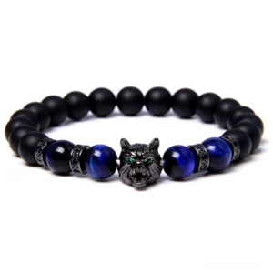Wolf charm elastic bracelet featuring black onyx and blue tiger eye stones with metal spacers, gothic aesthetic detail shot