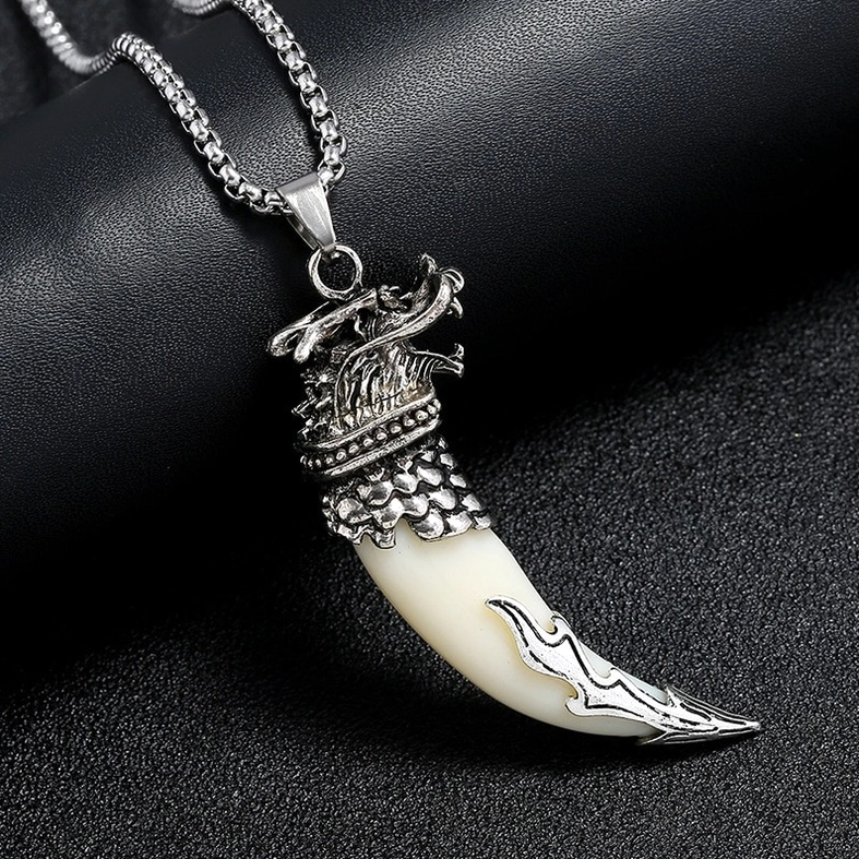 two gothic wolf tooth pendant necklaces side view on black display block dark background texture