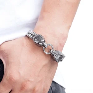 Wolf head stainless steel gothic bracelet worn on male wrist, close-up side view showing detailed carving and chain links in daily wear
