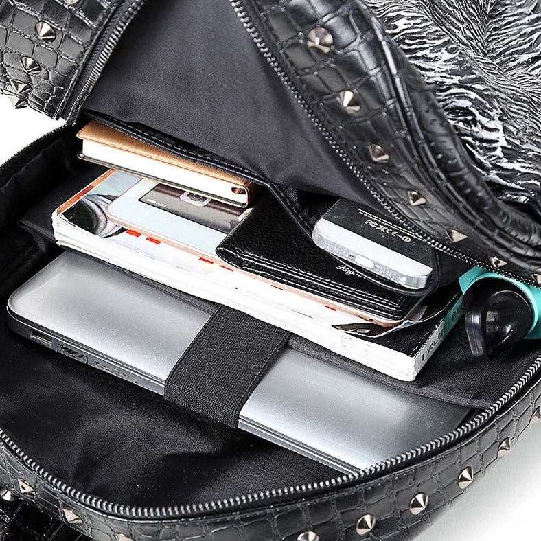 Gothic wolf backpack interior showing laptop compartment, linen lining, and organizational pockets