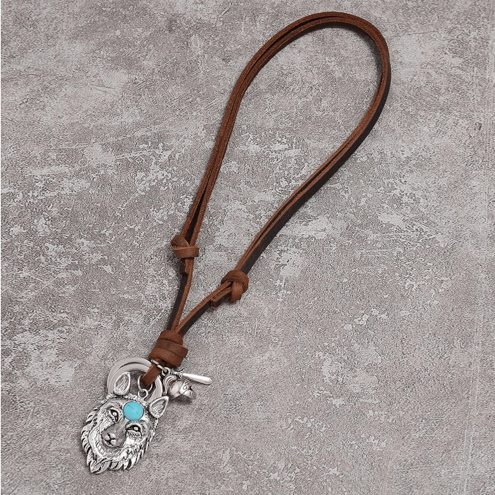 Intricate silver wolf head pendant necklace with turquoise accent stone, side oblique view