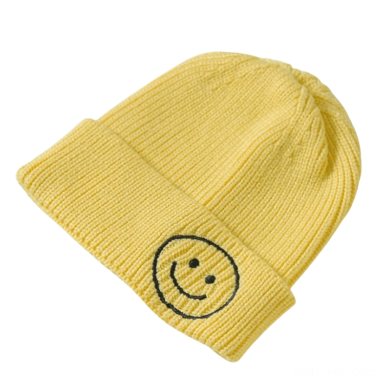 Yellow knit beanie with black smiley face embroidery, cheerful gothic aesthetic